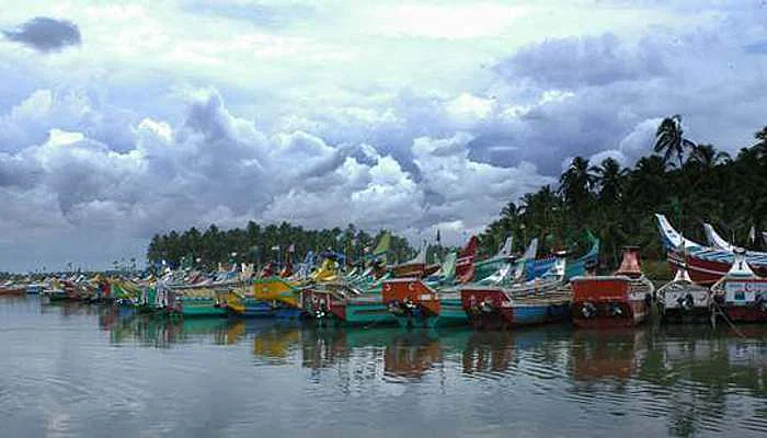 Several colorful boats stationed at Kozhikode Lake